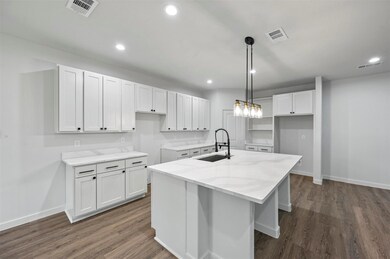 Kitchen featuring sink, decorative light fixtures,