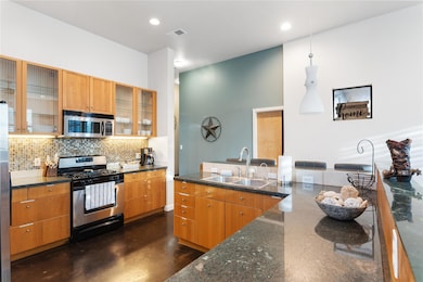 Kitchen with stainless steel appliances, tasteful