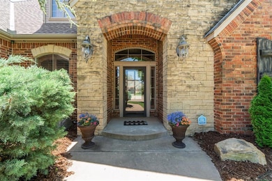 Entrance to property with brick siding, roof with shingles, and stone siding