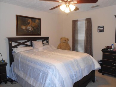 Bedroom with carpet and a ceiling fan