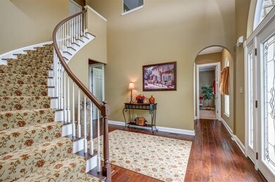 Enjoy the beauty of the sweeping staircase in this