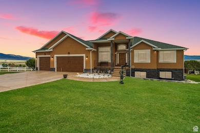 Ranch-style house with concrete driveway, a garage, stucco siding, a mountain view, and stone siding