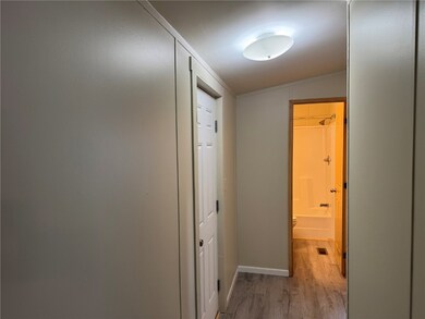 Corridor with crown molding and LVP flooring.  BRA