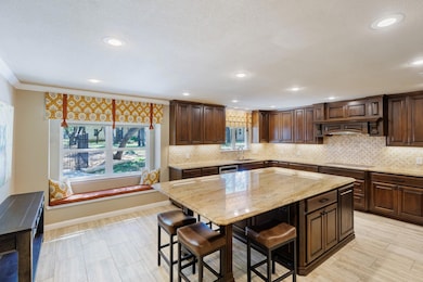 Kitchen featuring a kitchen breakfast bar, light 