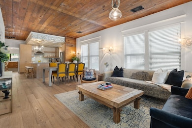 Living room featuring wooden ceiling, light wood-