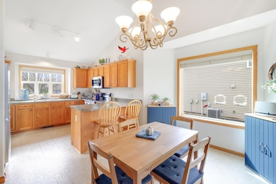Kick-out counter with breakfast bar. The vaulted ceilings and big windows make this a truly cheery place to enjoy gathering around a meal.