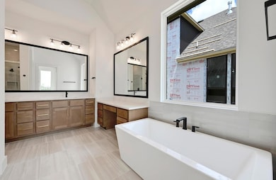 Bathroom featuring a freestanding bath, vanity, p