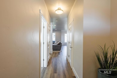 Hallway featuring wood finished floors and baseboards