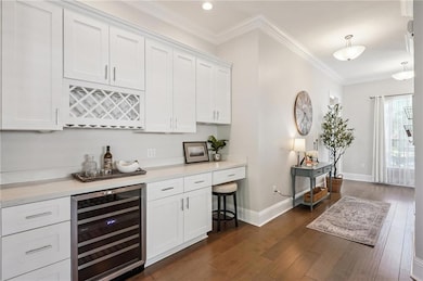 BAR AREA WITH WINE/BEVERAGE FRIDGE, WINE & GLASS STORAGE, DESK AREA, & PLENTY OF CABINETS