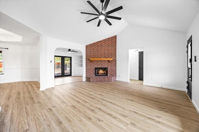 Unfurnished living room featuring ceiling fan, a 