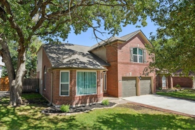 Traditional home featuring brick siding, driveway, an attached garage, and roof with shingles