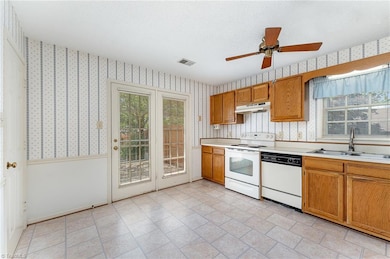 Door leads to private, fenced backyard with deck and patio