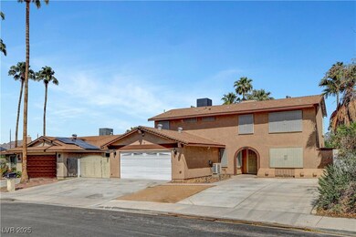 View of front facade with stucco siding, driveway,
