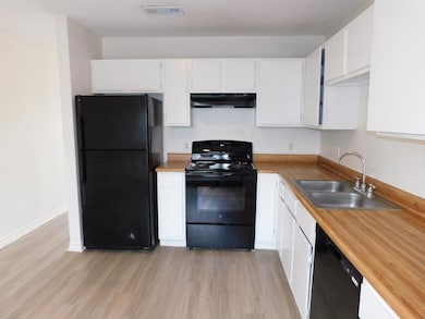 Kitchen with a sink, light wood-style flooring, u