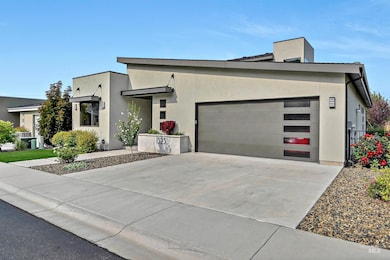 Modern home with stucco siding, driveway, and an attached garage