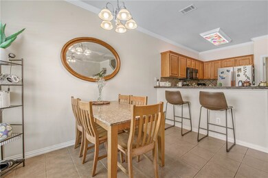Dining room featuring ornamental molding, light ti