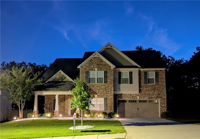 Craftsman inspired home with concrete driveway, brick siding, a garage, and a front lawn
