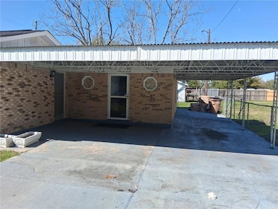 View of car parking with concrete driveway, a carp