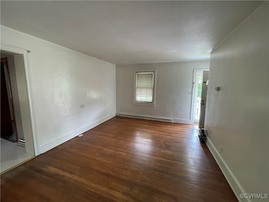 Spare room with a baseboard heating unit, wood fin