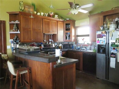 Kitchen with bar and under-counter refrigerator.