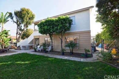 Nice grassy front yard with attractive garden bed 