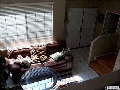 Double door entry into formal Living Room with cha