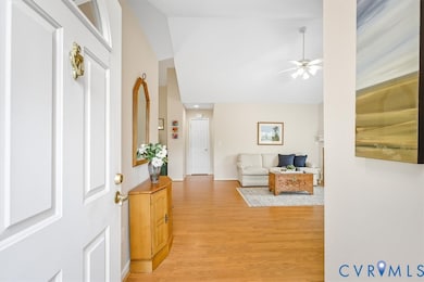 Entryway featuring light wood finished floors, a ceiling fan, and high vaulted ceiling