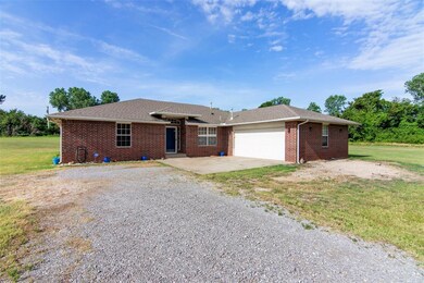 Single story home with a garage and a front yard