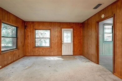 Spare room featuring wood walls and light colored 
