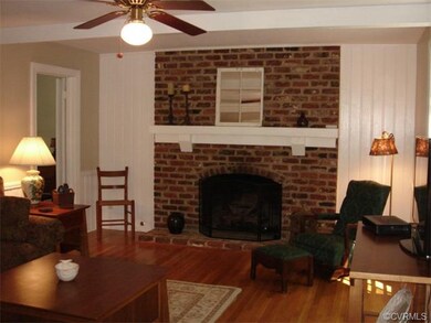 Family room with beautiful hearth with remote cont