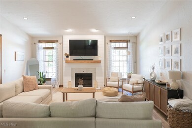 Living room featuring a fireplace, plenty of natural light, and hardwood / wood-style floors