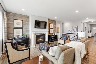The living room offers a great place to entertain or relax by the beautiful gas fireplace. (Photo of a decorated model, actual homes finishes will vary)