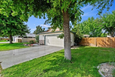 View of front of house with an outdoor structure, driveway, and stone siding