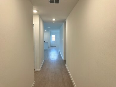Hallway with recessed lighting, visible vents, baseboards, and dark wood-type flooring