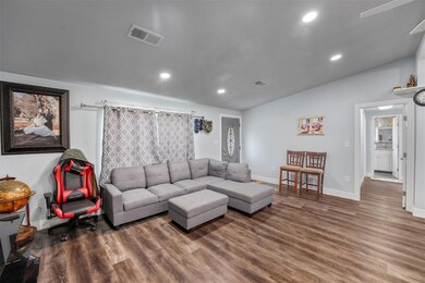 Living room with hardwood / wood-style flooring