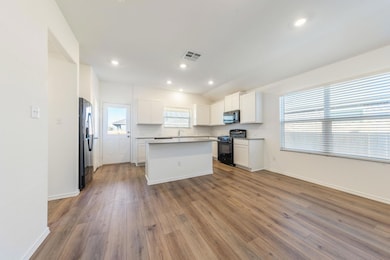 Kitchen featuring a center island, white cabinets