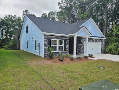 Craftsman-style house featuring stone siding, concrete driveway, a front lawn, an attached garage, and roof with shingles