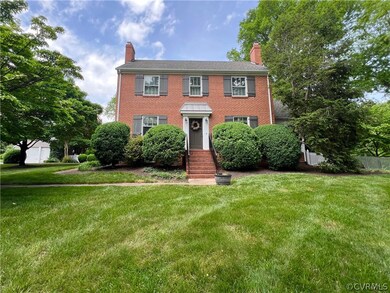 Colonial home with a large front lawn