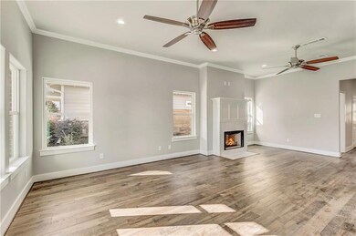 Great room with ceiling fans, fireplace, hard wood