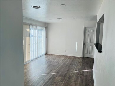 Empty room with dark hardwood / wood-style floors