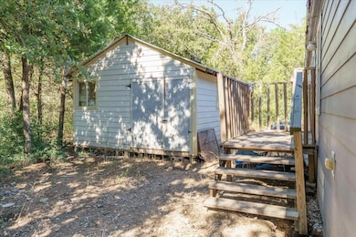 View of side of property featuring an outdoor structure