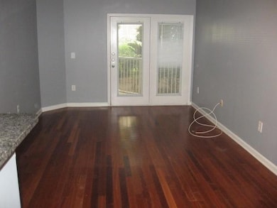 Unfurnished room with wood finished floors and bas