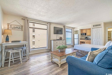 Living area with light wood-style flooring, visibl