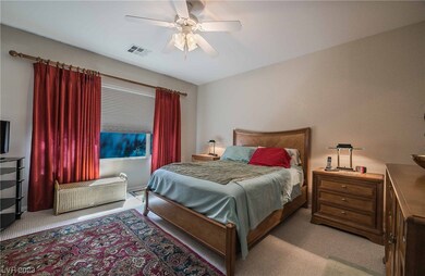 Primary bedroom downstairs with ceiling fan, plus