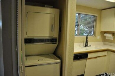 stackable washer and dryer next to kitchen