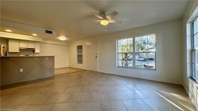 Unfurnished living room with ceiling fan and light