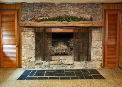 Beautiful stone fireplace is the focal point of th