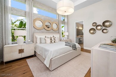 Bedroom with wood finished floors and ensuite bath