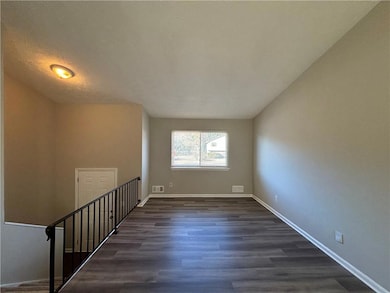 Spare room featuring baseboards, visible vents, an