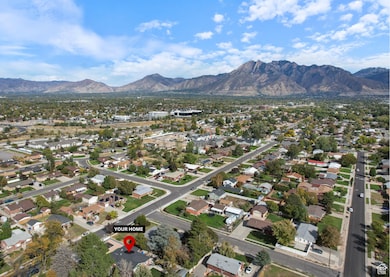 Aerial view of property's location with mountains and nearby suburban area